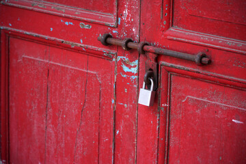 Close up of heritage red door with padlock    