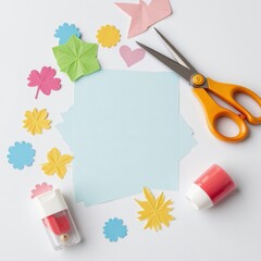 Cut-out paper shapes and scissors placed casually on white surface, with glue stick nearby for a creative mess vibe