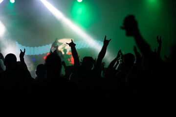 Crowd at concert and blurred stage lights.