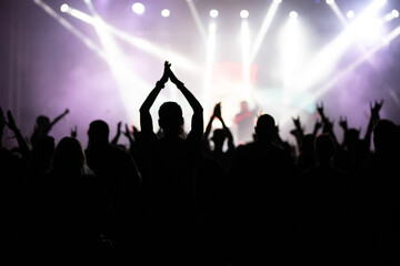 Crowd at concert and blurred stage lights.