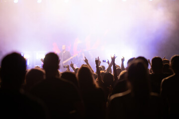 Crowd at concert and blurred stage lights.