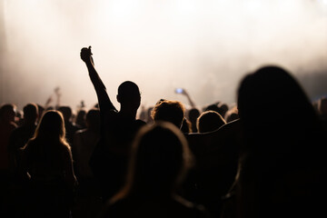 Crowd at concert and blurred stage lights.