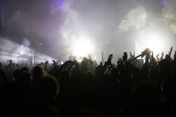 Crowd at concert and blurred stage lights.
