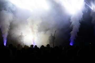 Crowd at concert and blurred stage lights.