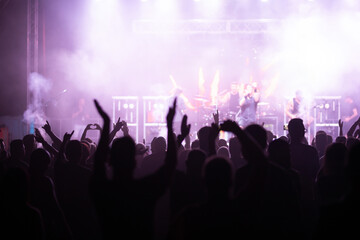 Crowd at concert and blurred stage lights.
