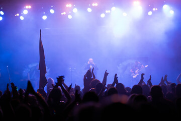 Crowd at concert and blurred stage lights.