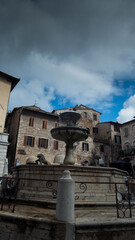 fountain of unità d'italia square in assisi in umbria