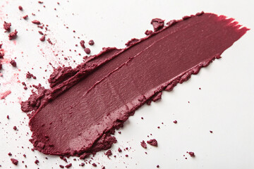 A high-pigment magenta beauty product is swatched, leaving a smooth and powdery texture.
