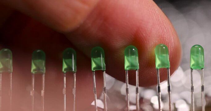 green light bulbs in a row on the printed circuit board for electronics, a large number of green light bulbs for signaling