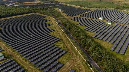 An aerial view of a solar power plant, also known as a solar park, is a large-scale photovoltaic...