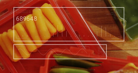Showing red plastic tray holding cheese sticks and green okra pods in kitchen, with digital overlay