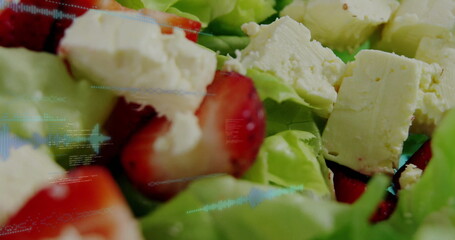 Salad featuring green lettuce strawberry slices, crumbled white cheese on plate, digital overlay