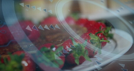 Displaying red strawberries sitting on white plate at wooden countertop, with interface overlays