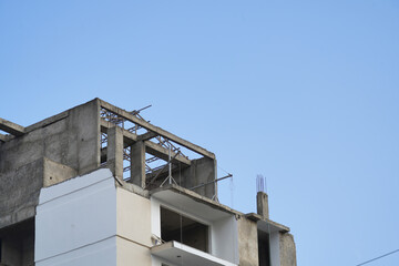 Construction site with cranes on beautiful sky background. Inside place for tall buildings under...