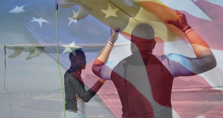 Walking father and son carrying yellow surfboard along beach shoreline, with gentle ocean waves