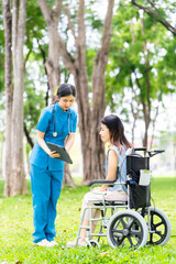 Caregiver takes elderly in wheelchair to walk in the park for health therapy, insurance concept for the elderly, happy retirement