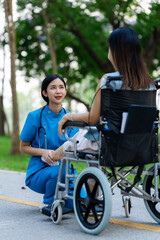 Caregiver takes elderly in wheelchair to walk in the park for health therapy, insurance concept for the elderly, happy retirement