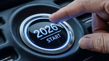 Finger pressing a glowing start button displaying the year 2026 symbolizing the beginning of a new year and future opportunities