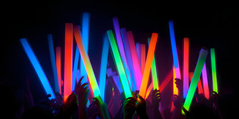 Vibrant neon streaks of light from glow sticks illuminate the atmosphere at a night celebration and rave, creating an exhilarating ambiance filled with color and excitement.