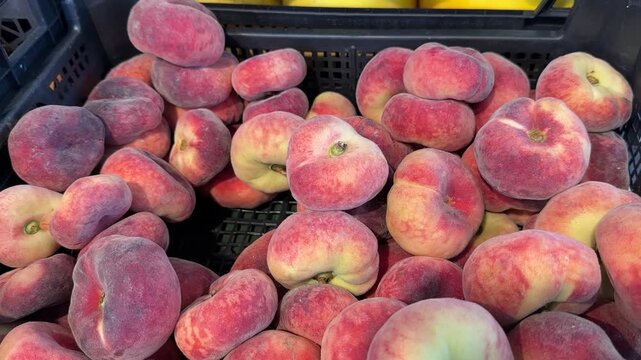 Fig peaches in a black box at the market or in the store