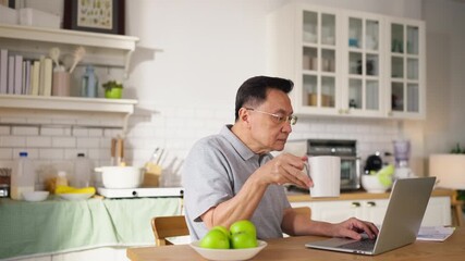 Asian senior couple sitting at the kitchen dining table, smiling warmly as they video call their grandson to celebrate his birthday online. Embracing technology, the grandparents use a digital tablet - Powered by Adobe