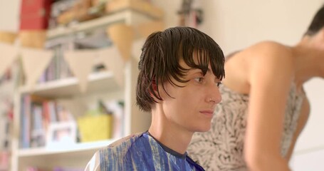 This video features hair cutting scenes in a salon, showcasing a stylist expertly trimming mens and childrens hair, highlighting personal interactions