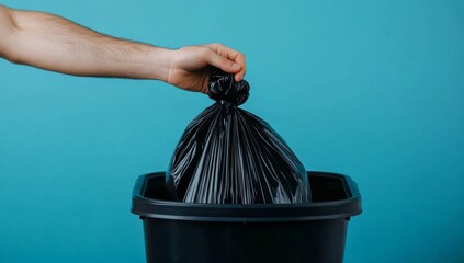 Hand Putting Black Trash Bag in Bin, Waste disposal , Recycling