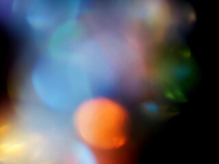Colorful light leaks on black background for design and special effects. Retro film look. Abstract...