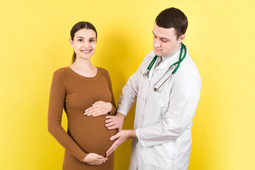 Happy doctor caring about young pregnant woman. doctor using hand examining pregnant woman in clinic
