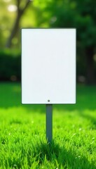 Crisp white sign contrasts vibrant green grass, yard, bright