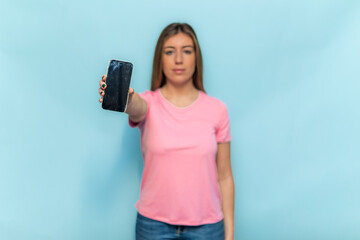 Woman showing broken smartphone screen wearing pink t-shirt for Breast Cancer Awareness