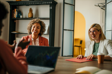Businesswomen having a productive meeting, sharing ideas and laughing together