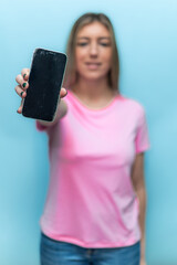 vertical Woman showing broken smartphone screen wearing pink t-shirt for breast cancer awareness