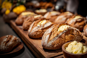 Creative food concept. Rows of artisan bread with whipped cream butter custard on wooden serving board in rustic cafe shop bakery catering. copy text space