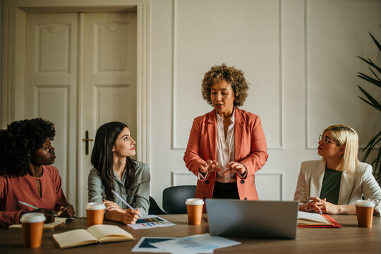 Senior manager leading a business meeting with her team in the office
