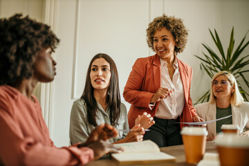 Businesswomen collaborating on project during office meeting