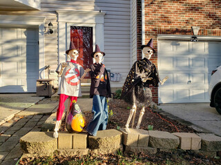 Skulls on the threshold of a house decorated for Halloween.