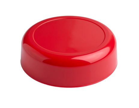 A red disc of ski wax, used for improving glide and protecting skis, isolated on white.