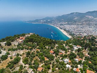 Drone view of Alanya city, Turkey. Coastline, Mediterranean Sea, harbor, historic castle on the...