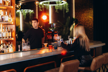 Modern Bar Scene With a Bartender and a Customer in Dim Lighting
