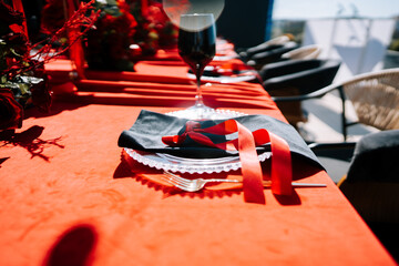 Elegant table setting decorated with red accents for a festive gathering