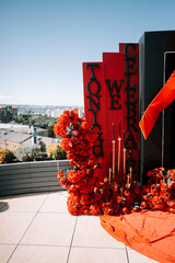 Celebration setup with vibrant red flowers and decorations for an evening event
