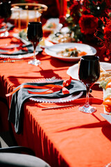 Elegant table setting with black and red decor for a festive celebration