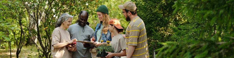 Header of multiethnic adults and teenagers standing outdoors sharing gardening tools and potted plants, smiling and interacting together