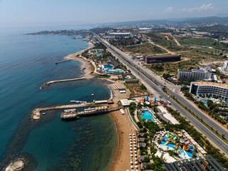 Obraz premium Stunning aerial day view over Turkler in Alanya, Turkey. Alanya coastline,resorts,marina,hotels and crystal clear turquoise water along the Mediterranean Sea. Mediterranean Sea turquoise coastline.