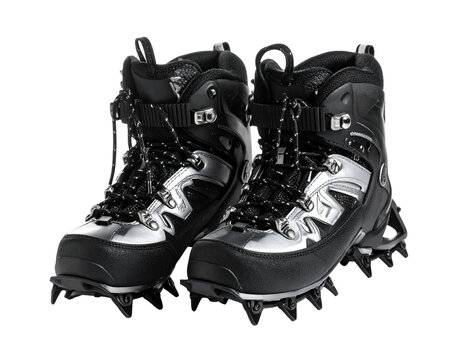 A pair of metal crampons with straps, essential traction gear for ice climbing and mountaineering, isolated on white.
