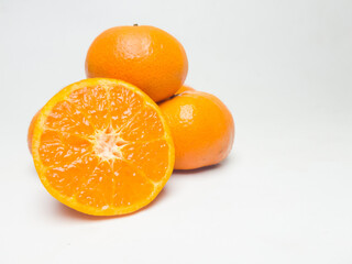 Fresh oranges with cut in half isolated on white background.