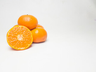 Fresh oranges with cut in half isolated on white background.
