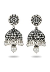 Traditional Indian silver jhumka earrings with intricate design and pearl accents isolated on white background