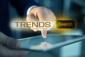 Businessman using tablet computer to find hot tendencies, new ideas, popular directions, closeup....
